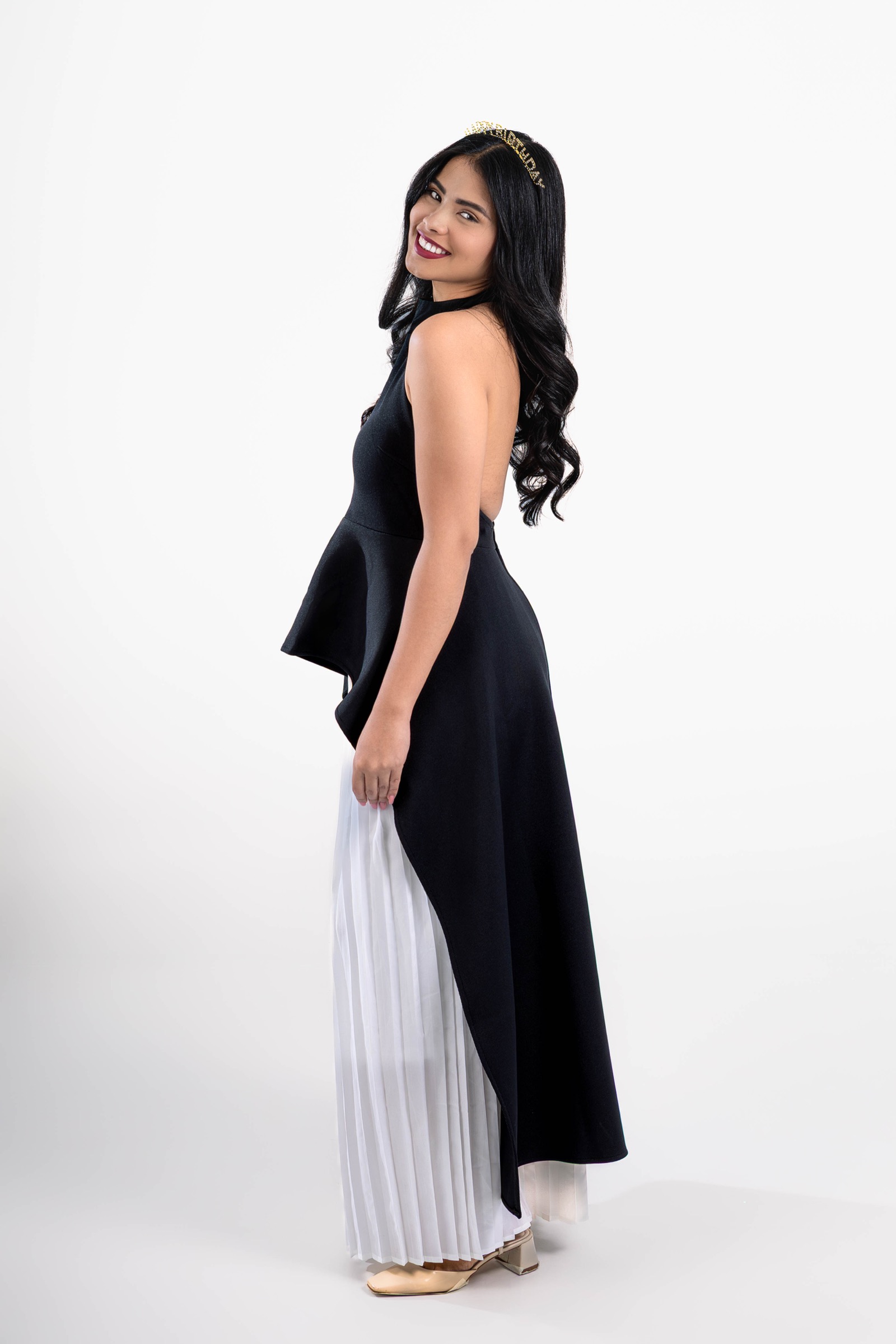 Retrato de una mujer de perfil con vestido negro y blanco en estudio